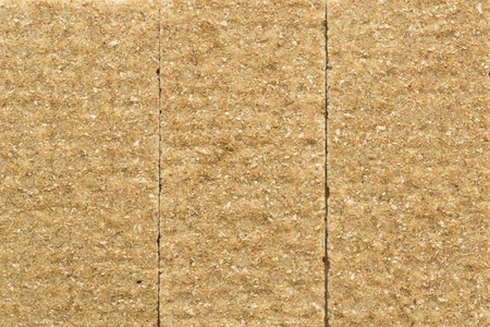 Crisp rye bran bread texture background with vertical seams