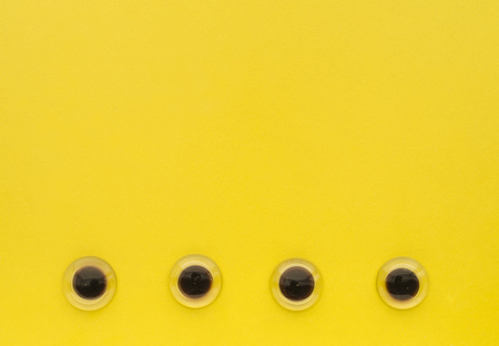 Yellow Color  with eyes like glass pebbles backgroundの写真素材