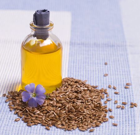 Flax seeds, linseed oil and flowers close-upの写真素材