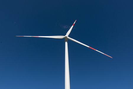 Wind turbines generate electricity with blue skyの写真素材