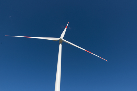 Wind turbines generate electricity with blue skyの写真素材