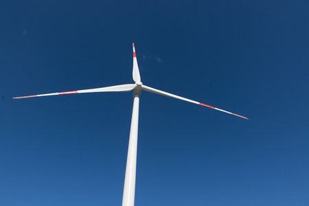 Wind turbines generate electricity with blue skyの写真素材
