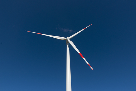 Wind turbines generate electricity with blue skyの写真素材