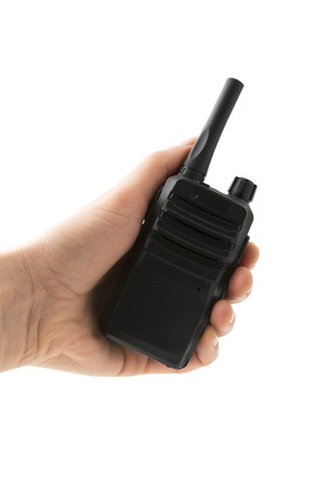 Portable radio transceiver in hand, isolated on white background photoの写真素材