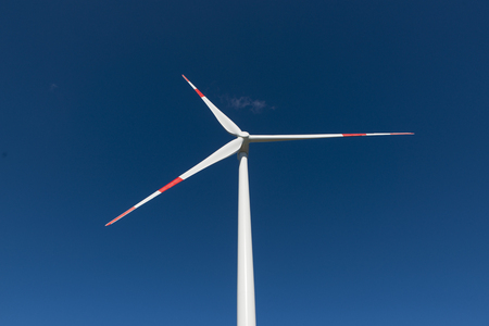 Wind turbines generate electricity with blue skyの写真素材