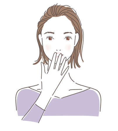 Woman putting her hand on her mouthの写真素材