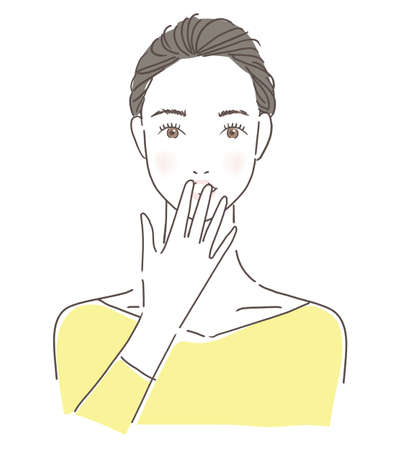Woman putting her hand on her mouthの写真素材