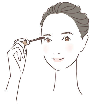 Woman applying mascaraの写真素材