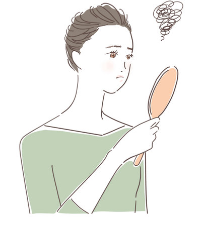 Woman looking in the mirrorの写真素材