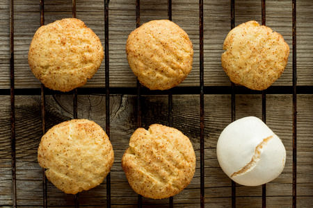 Shortbread cookies and merengue on wire rack wooden table top viewの写真素材