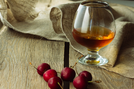 Brandy glass and black cherry horizontal selective focusの写真素材