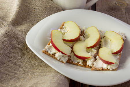 Crisp bread with cream cheese and apples horizontal selective focusの写真素材