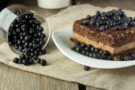 Chocolate cake with blueberry and glass with berries, selective focusの写真素材
