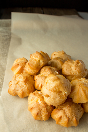 Cream puffs on cooking paper selective focusの写真素材