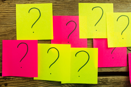 Sticky papers with question marks top view