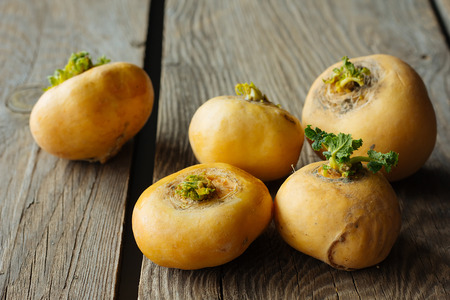 Five turnips on wooden table selective focusの写真素材
