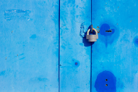 Metal lock on blue wall selective focus horizontalの写真素材