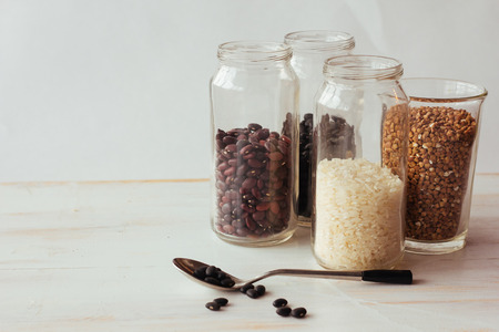Beans, rice and buckweath in glasses selective focus