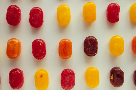 Multicolored candies over white selective focusの写真素材