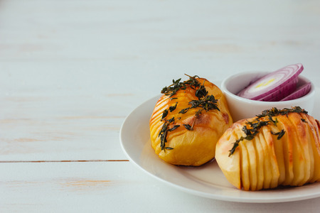 Baked potatoes and onion copy space selective focus