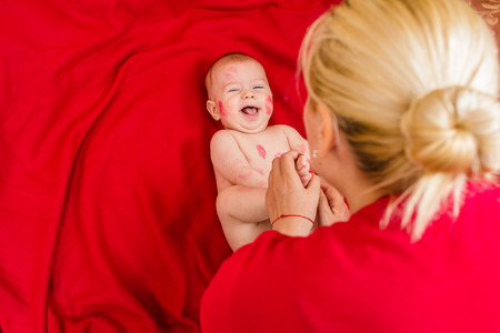 an image of cute baby covered with kissesの写真素材