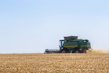 Khmelnitskiy, Ukraine - July 23: Modern John Deere combine harvesting grain in the field near the town Khmelnitskiy, Western Ukraine July 23, 2015のeditorial素材