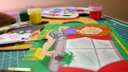 Man in the process of drawing with acrylic paints picture of girlの写真素材