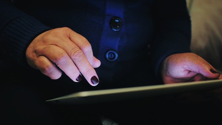 A middle-aged woman uses her tabletの写真素材