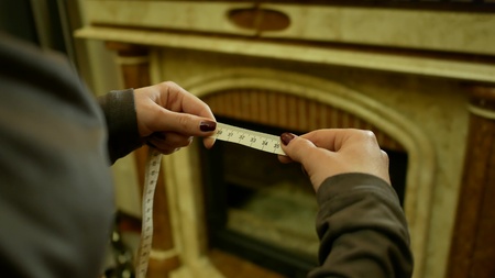 Tape measure in centimeters. Woman holding rouletteの写真素材