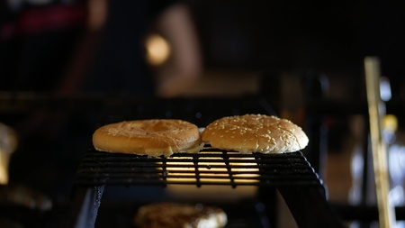 Burger cooking on the grill at the restraunt kitchenの写真素材