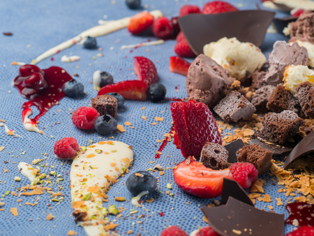 Strawberry and other berries lying in delicious sauce and chocolate.の写真素材