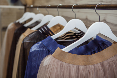 fashion skirts and clothing on hangers at the showの写真素材