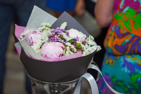 Beautiful bouquet of flowers standing in a metal bucket during a partyの写真素材