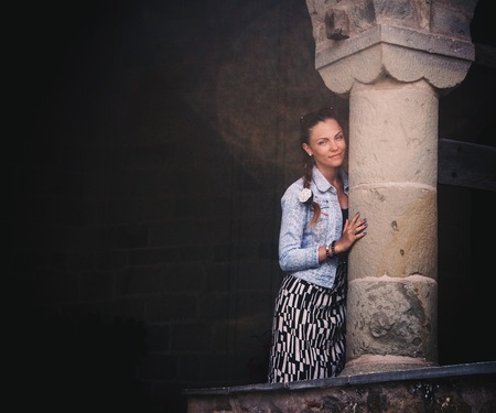 Beautiful woman in long skirt posing near ancient column in Meteora Monastery Greece. Wonderful architectureの写真素材