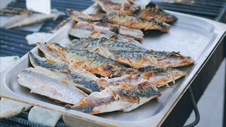 Grilled scomber fish on a tray. Outdoor summer barbecue