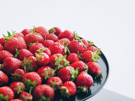 Fresh, ripe, juicy strawberries. Appetizing berries with droplets on a trayの写真素材