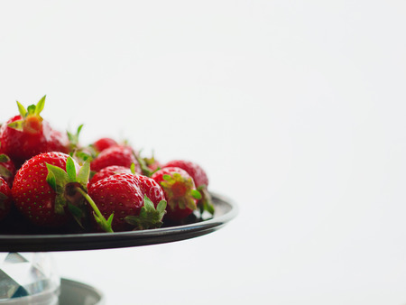 Fresh, ripe, juicy strawberries. Appetizing berries with droplets on a tray. Background with copy spaceの写真素材