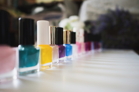 Set of different nail varnishes on shelves in cosmetic storeの写真素材