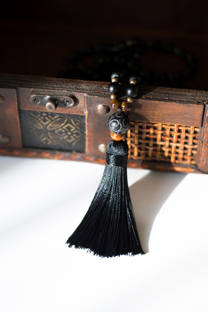 Beautiful handmade mala gems beads with tassel for mantras and meditation. Casket background.の写真素材