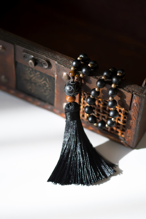 Beautiful handmade mala gems beads with tassel for mantras and meditation. Casket background.の写真素材