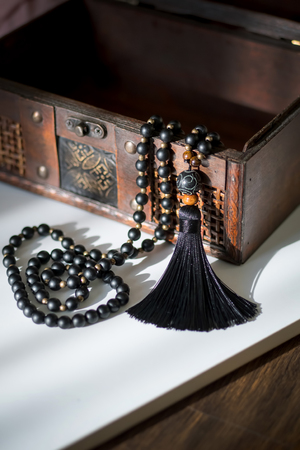 Beautiful handmade mala gems beads with tassel for mantras and meditation. Casket background.の写真素材