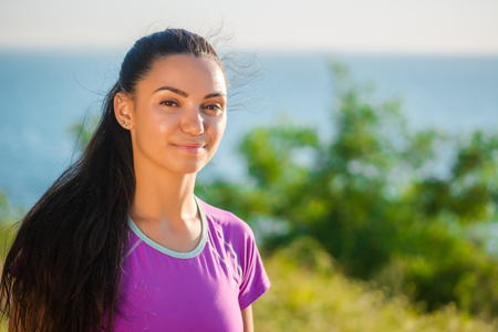 Profile portrait of happy sporty woman relaxing in park. Female model relaxing, breathing fresh air outdoors. Healthy active lifestyle concept. Copy spaceの写真素材