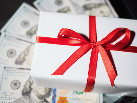 Present gift box with red ribbon on money holidays concept.の写真素材