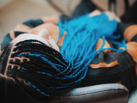 Top view on woman's hand with african braids. She sitting in beauty salon.の写真素材