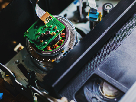 tape inside a VCR player, reels moving while reading the contents. Close-up detail shot.の写真素材