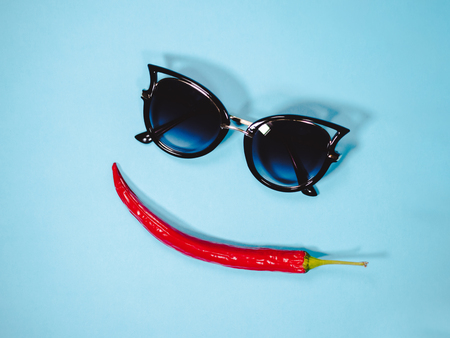 Black sunglasses object accessory fashion style. Funny face with lips made from red hot pepper chile.の写真素材
