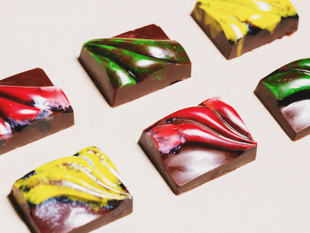 chocolate handmade candies. chocolates without heat treatment lie on wooden table with cracked paint on the surface. raw food diet concept. rustic styleの写真素材