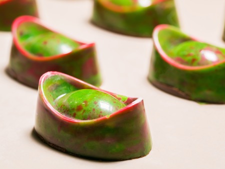 Set of colorful luxury handmade green bonbons on white background. Exclusive handcrafted chocolate candies. Product concept for chocolatierの写真素材