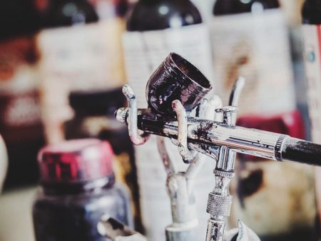 Old airbrush device in leather local workshop. Close upの写真素材