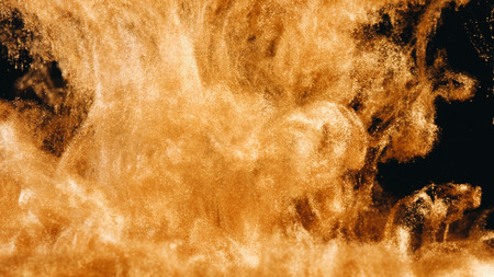 Ink in water. Colour golden glitter paint reacting in water creating abstract cloud formations.の写真素材